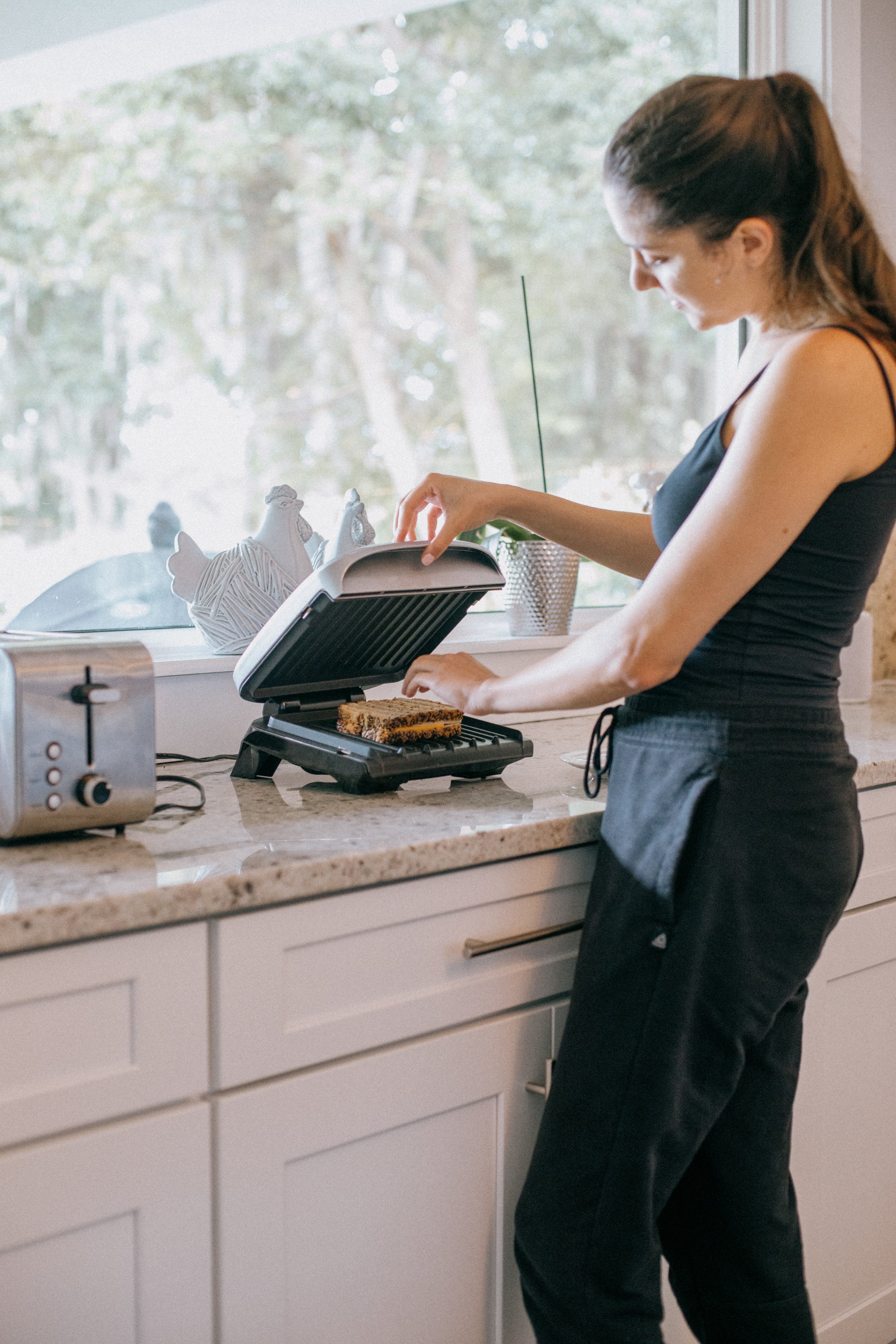 person-places-a-sandwich-into-a-panini-press.jpg